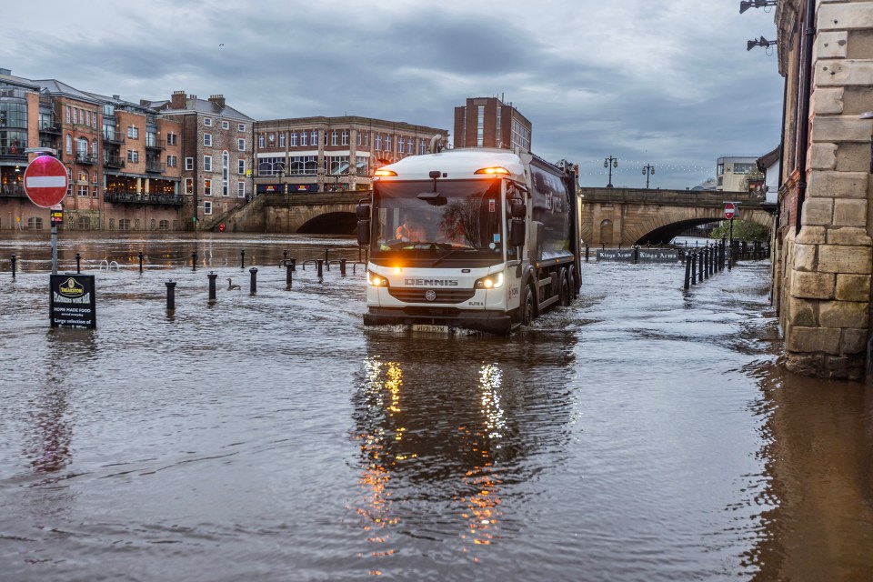 A bin lorry braves the flooded streets of York