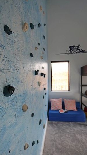 Their son's bedroom features a climbing wall