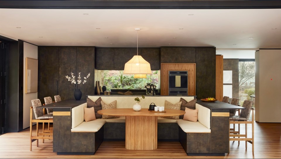 Stunning kitchen features a breakfast table facing out over the garden