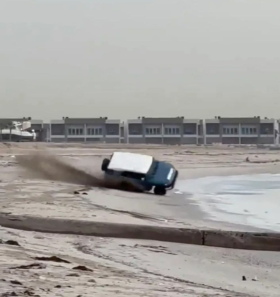 The moment the 4x4 appears to catch an edge and begins to roll along the sand