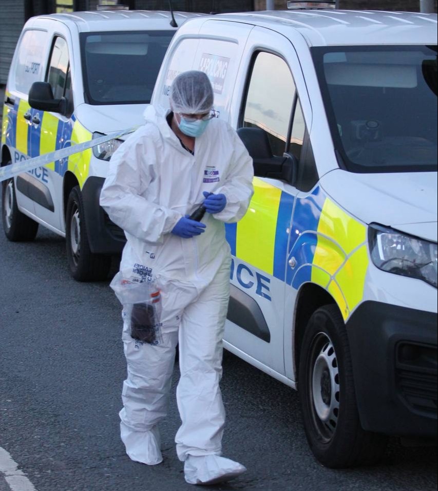 Forensic officers at the scene of the horror knifing