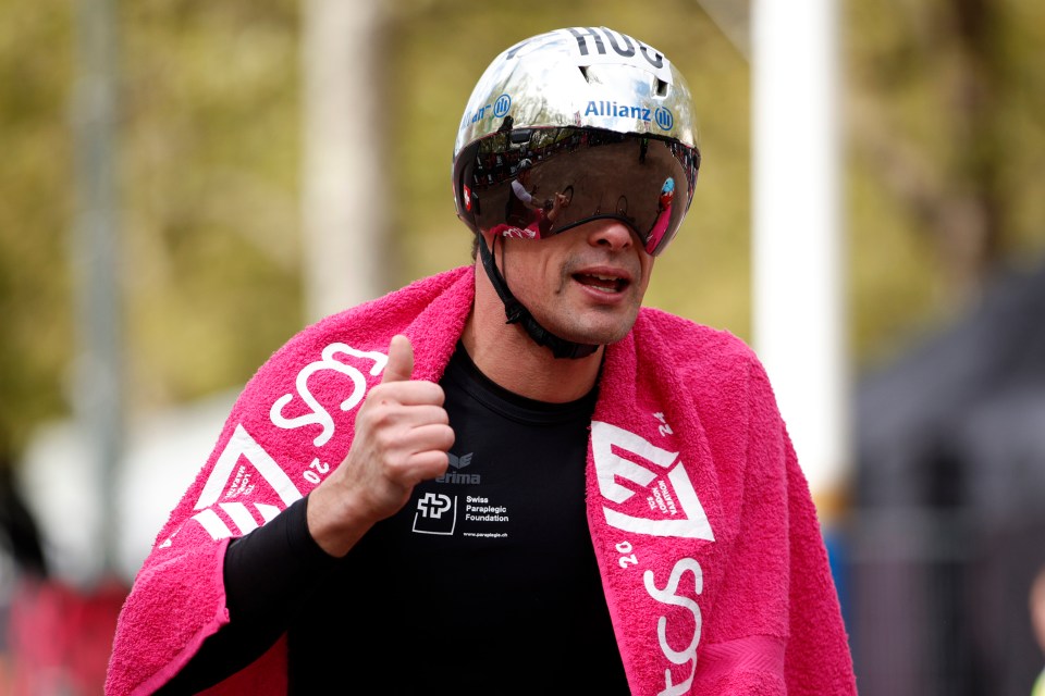 Marcel Hug of Switzerland reacts after crossing the finish line to win the men's wheelchair race at the London Marathon in London, Sunday, April 21, 2024.(AP Photo/David Cliff)