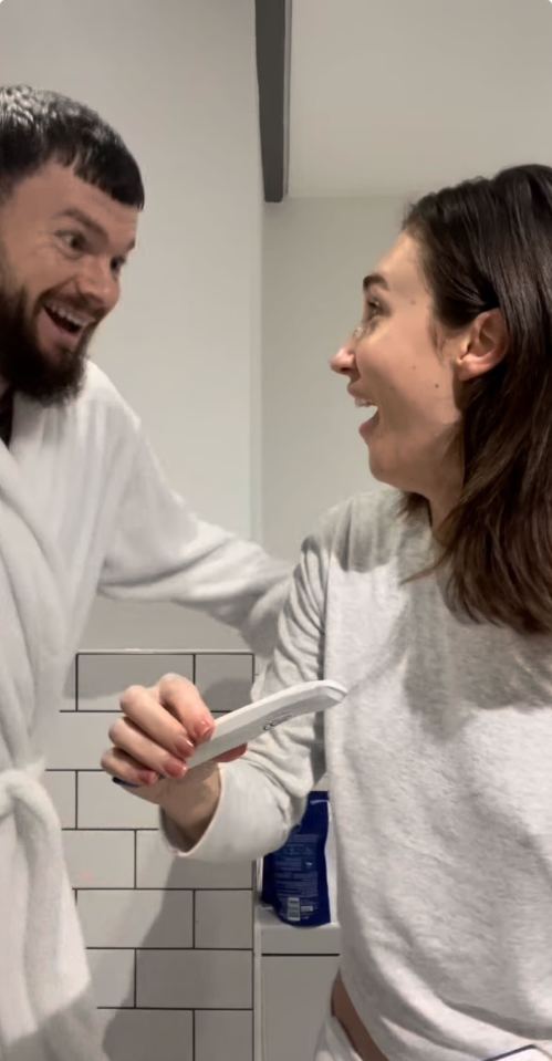 The couple look delighted after taking a pregnancy test