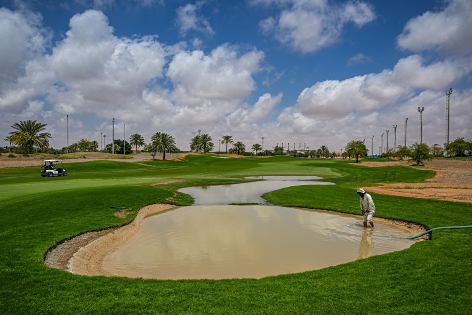 ABU DHABI, UNITED ARAB EMIRATES - APRIL 17: Grounds Staff drain water from the flooded bunker area on the course prior to the Abu Dhabi Challenge at Al Ain Equestrian, Shooting and Golf Club on April 17, 2024 in Abu Dhabi, United Arab Emirates. (Photo by Octavio Passos/Getty Images)