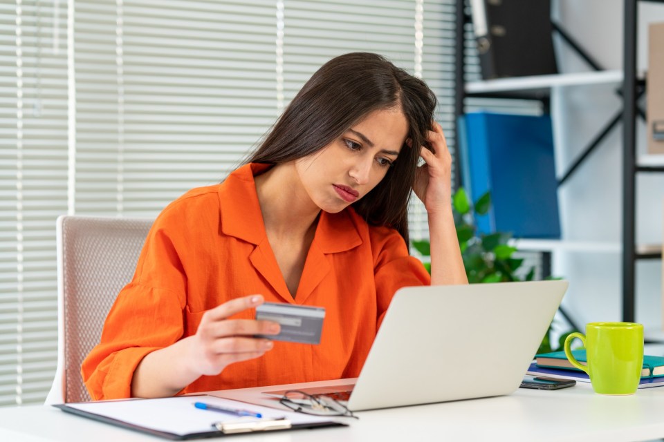 Financial problems, unsuccessful online shopping. Shocked woman with laptop and credit card