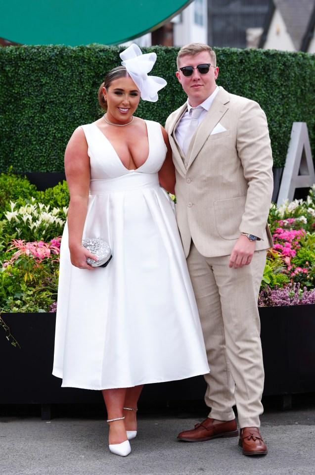 One guest looked angelic in a white midi dress with matching fascinator