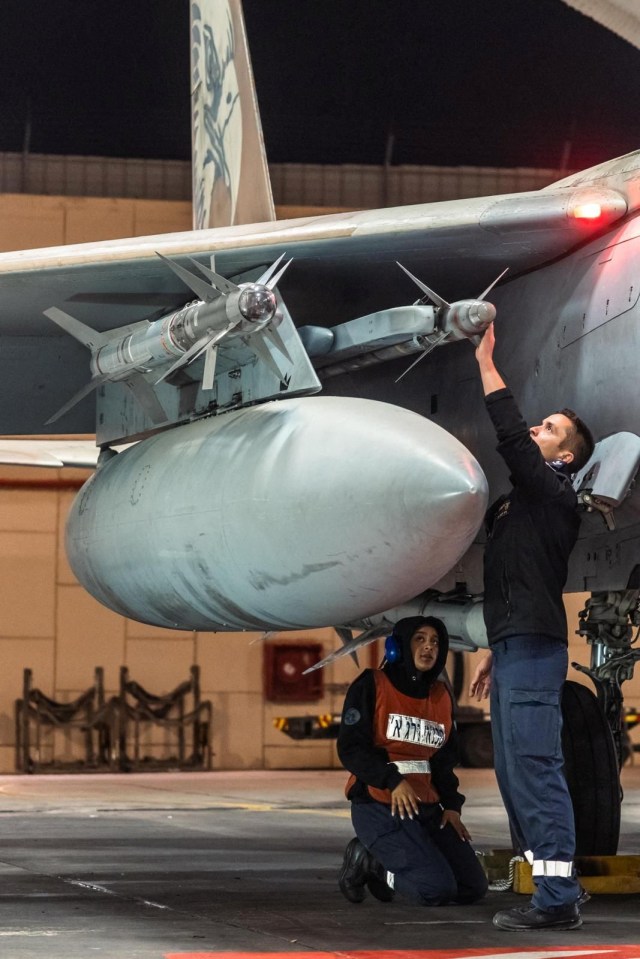 A crew checks the missiles on an Israeli F-15 Eagle