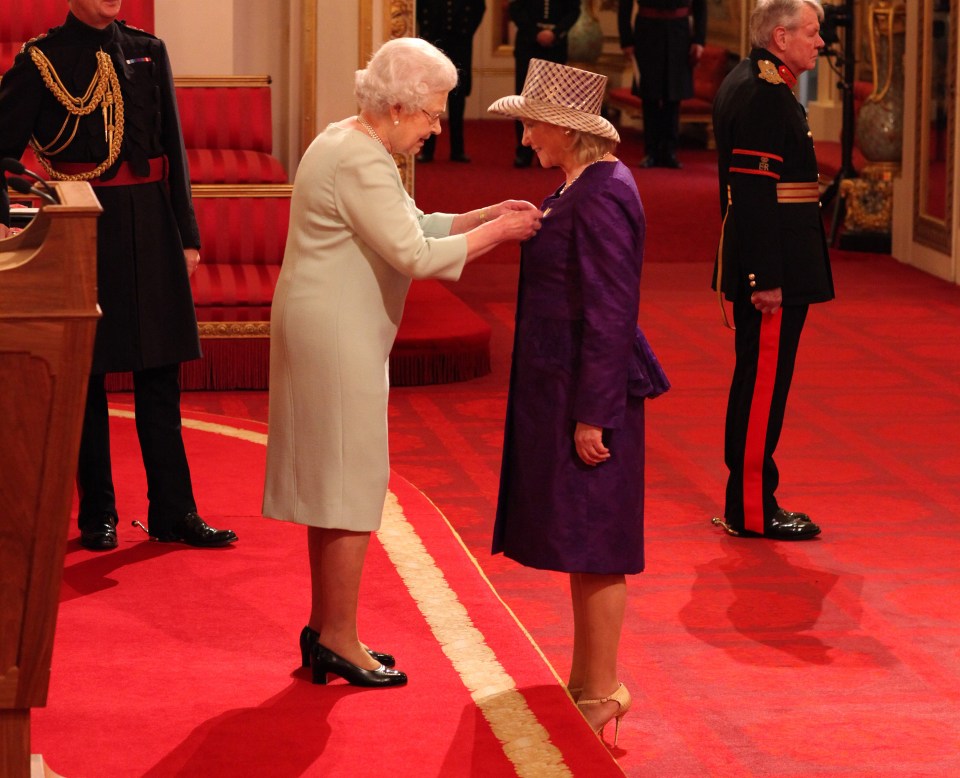 Angela being made a Lieutenant of the Royal Victorian Order by Queen Elizabeth II