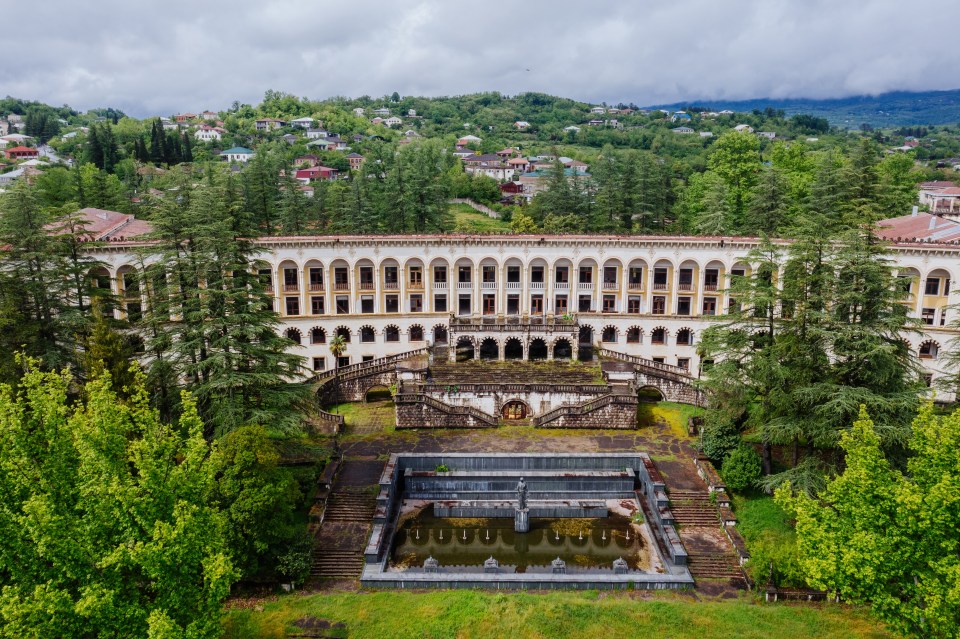 Aerial view of ruined overgrown old abandoned Soviet sanatorium Miner, Tskaltubo, Georgia