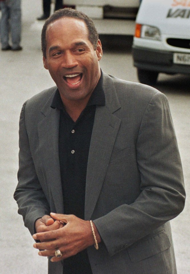 OJ Simpson laughs as he arrives at Granada studios in Manchester on May 13, 1996