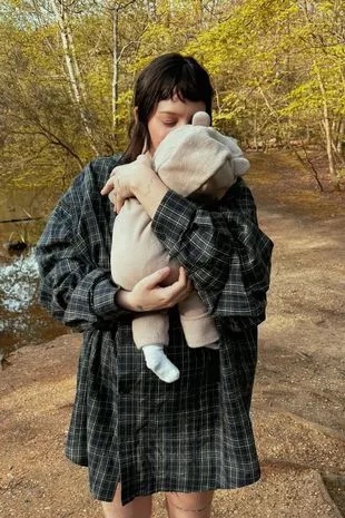 The singer snuggled up to her baby girl who wore a cute bear all-in-one