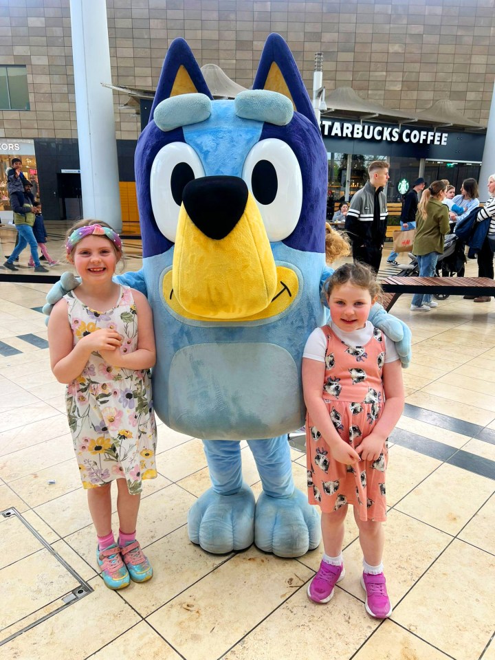 Young fans Freya, seven, and Roisin, five with their hero