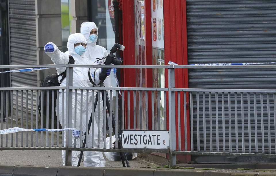 Forensic officers at the scene of the city centre knifing