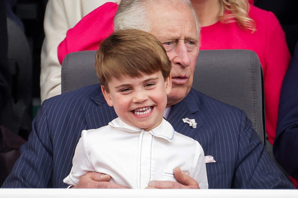 The youngster on his grandfather King Charles's lap