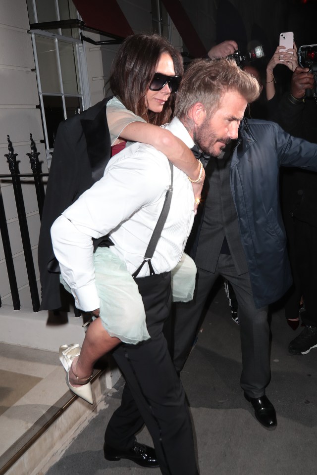 Victoria got a piggy back from David as they left her £250,000 birthday bash