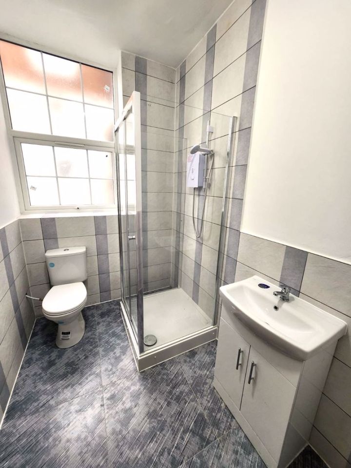 A sizable bathroom comes with a spacious shower