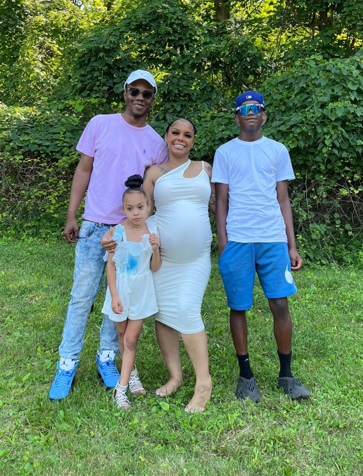 Starla with her family while pregnant with her third child Amaris