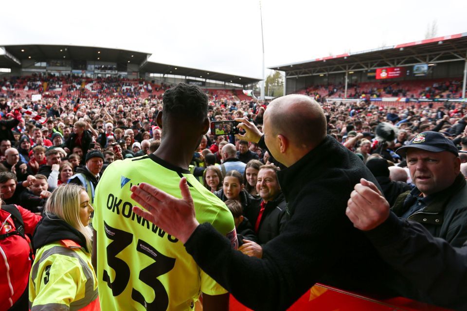 Fans at Wrexham stormed the SToK Cae Ras in celebration after the final whistle