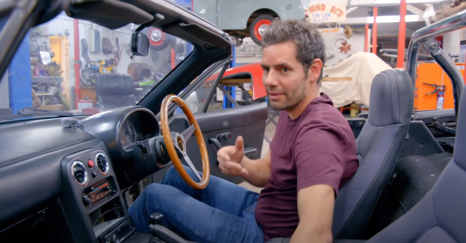 Elvis begins by changing the wooden steering wheel with a racing one