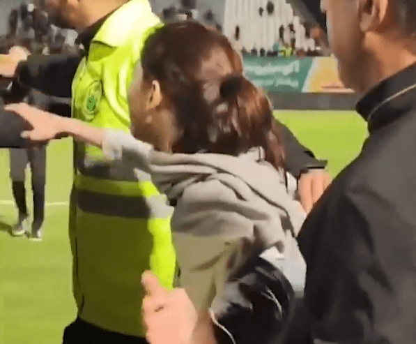 The female fan’s hijab reportedly fell as she made her way to the pitch