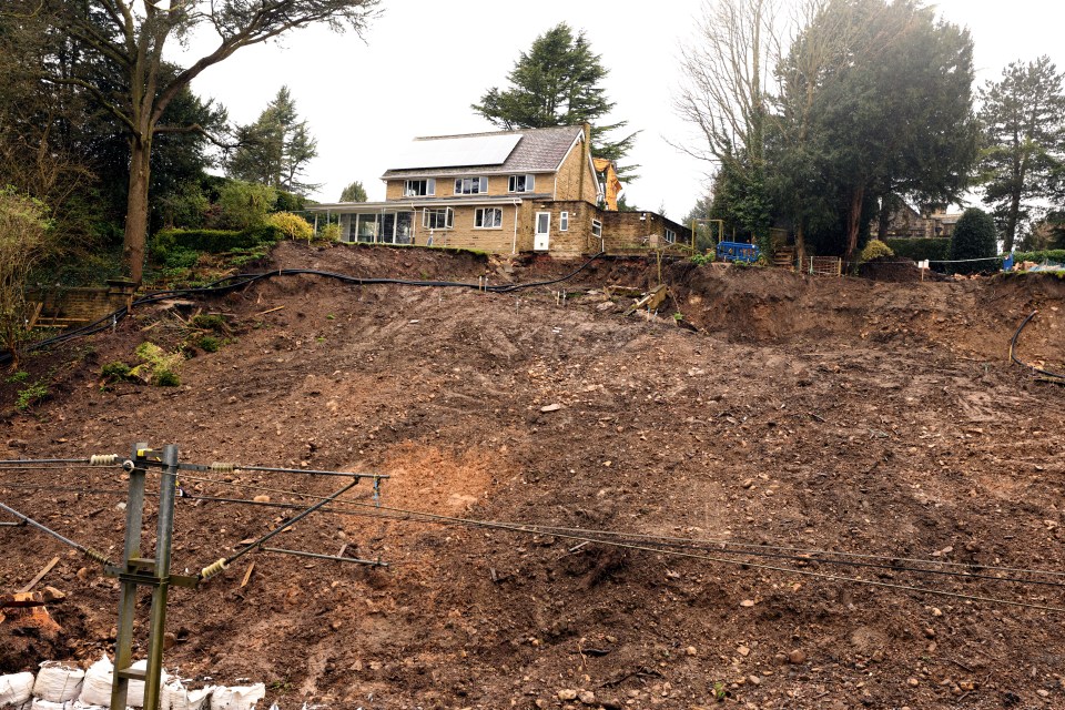 The extent of the landslide, with one home already now completely knocked down