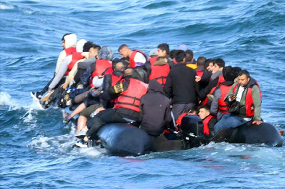 Illegal migrants are crammed onto a small boat crossing the English Channel