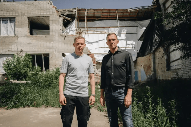 Zinchenko and Shevchenko at the destroyed school during their trip to Ukraine