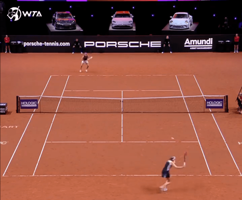 Three Porsches are on show behind the court in Stuttgart