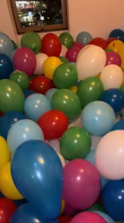 Tom came back home to find his room stuffed with balloons