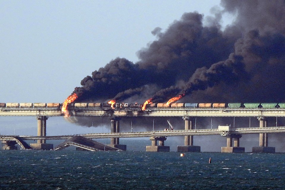 (FILES) In this file photo taken on October 08, 2022 Black smoke billows from a fire on the Kerch bridge that links Crimea to Russia, after a truck exploded, near Kerch. - Moscow announced on October 8, 2022 that a truck exploded igniting a huge fire and damaging the key Kerch bridge -- built as Russia's sole land link with annexed Crimea -- and vowed to find the perpetrators, without immediately blaming Ukraine. (Photo by AFP) (Photo by -/AFP via Getty Images)