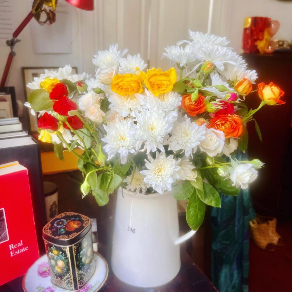 She has also stacked any spare space on her desk with flowers and more books