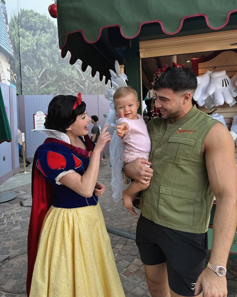 a man wearing a green vest with the word disney on it