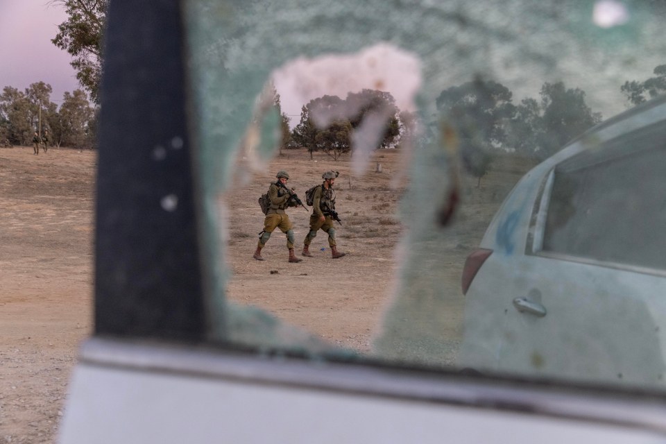 Soldiers are pictured as they secure the site of the festival and begin to count bodies