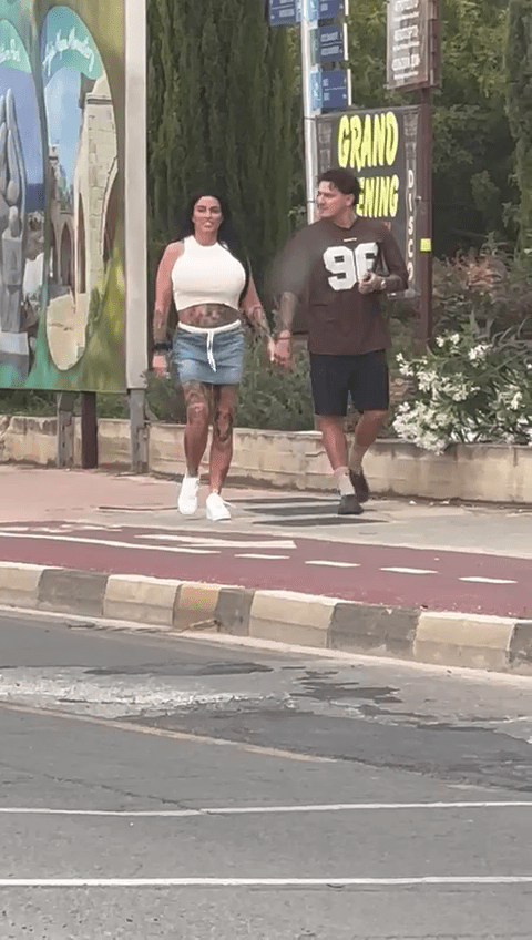 Katie wore a crop top and denim skirt for the afternoon walk