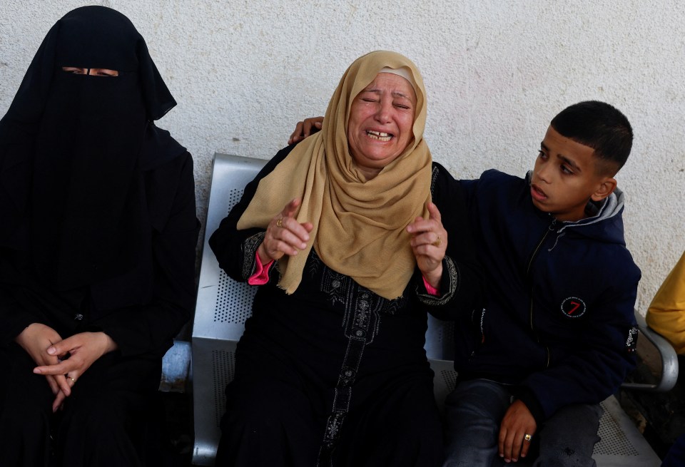 Mourners cry over the bodies of their loved ones killed in Israeli strikes