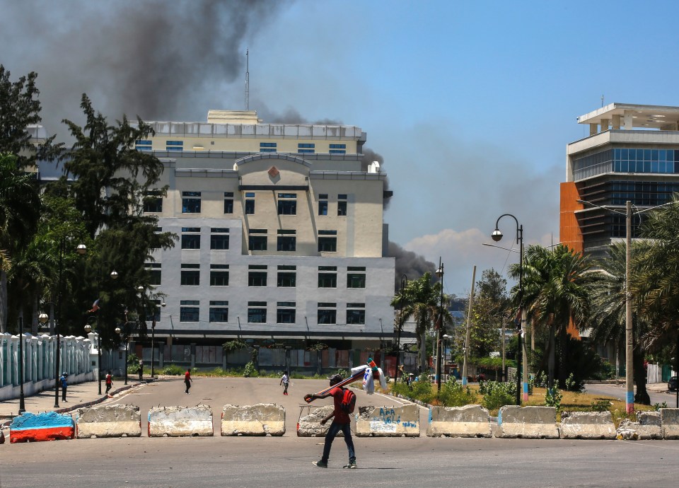 Smoke is seen rising close to the National Palace after frequent attacks by the gangs on the presidential residence