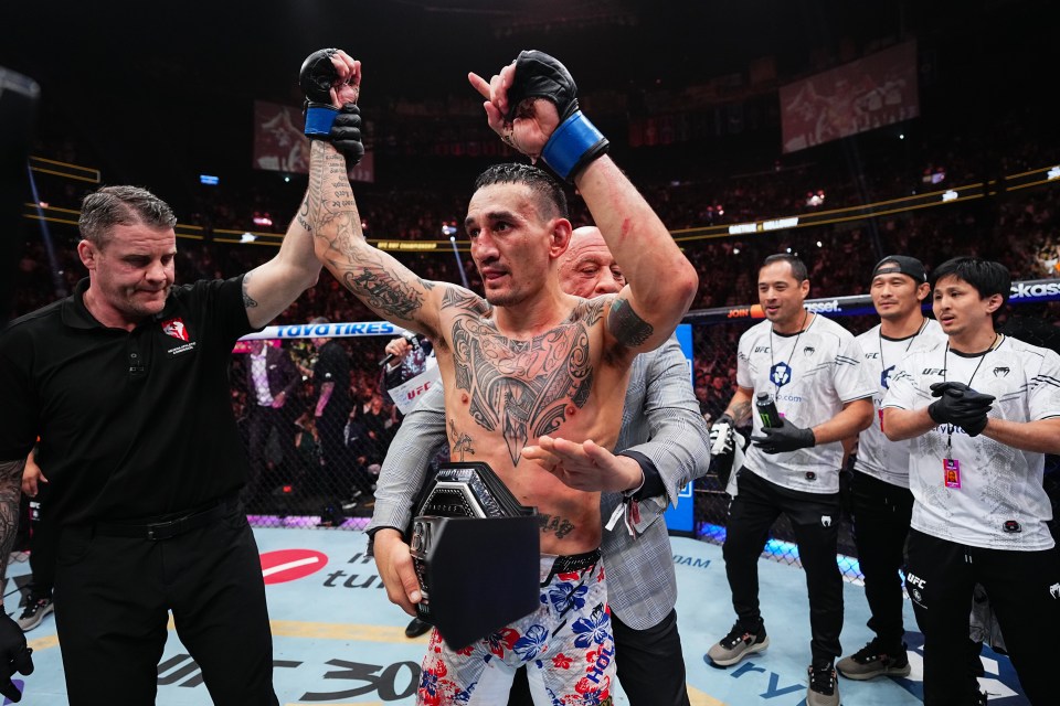 Max Holloway has the BMF title wrapped around him by Mark Coleman