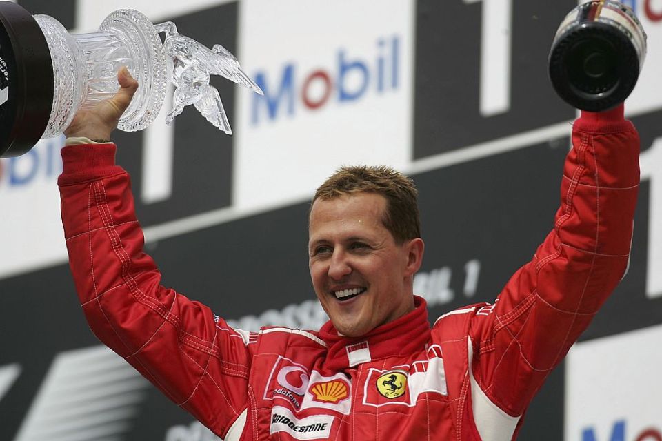 The F1 legend celebrates on the podium after winning the German Formula One Grand Prix at the Hockenheimring in 2006