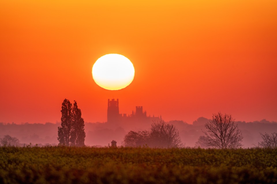 The sun rising over majestic Ely Cathedral in Cambs this morning