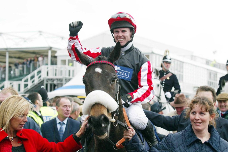 a jockey on a horse wearing a shirt that says tell