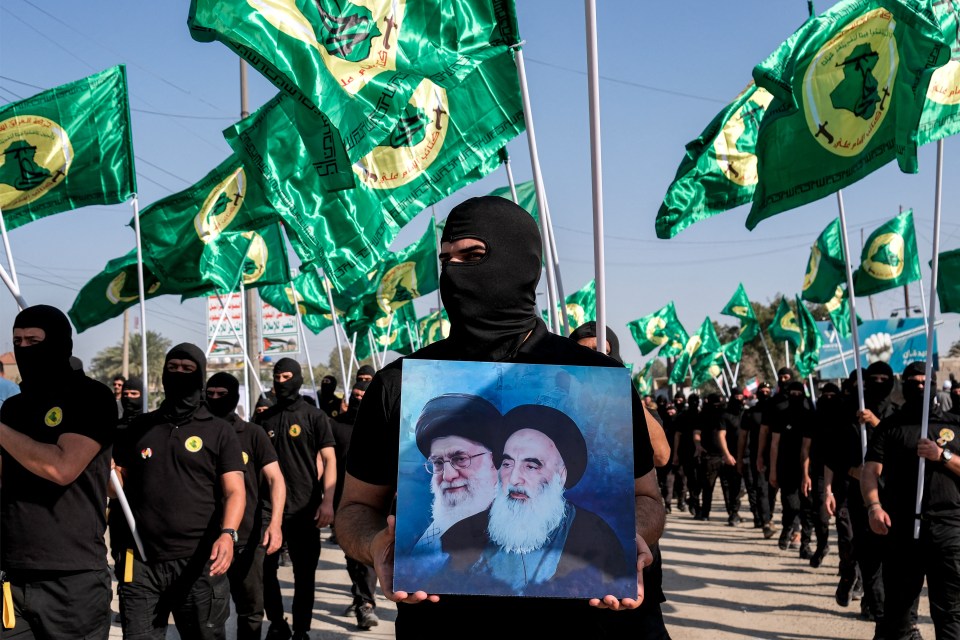 The Iraqi Popular Mobilisation Forces (PMF) paramilitary holding up a picture of Iranian leader Ayatollah Khomeini