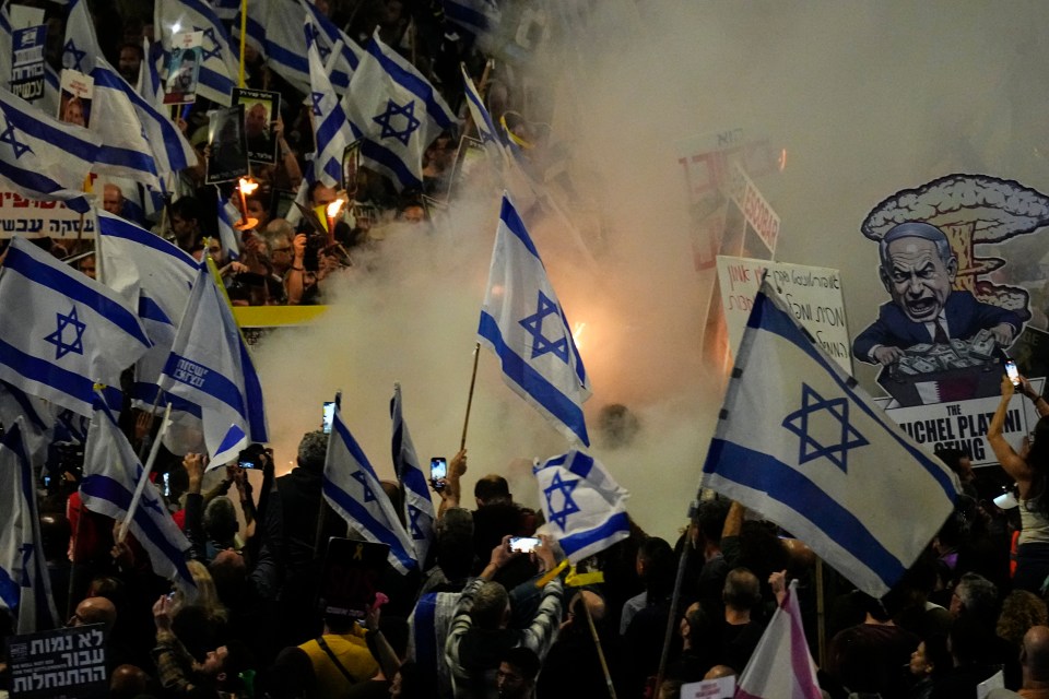 Holding dozens of Israeli flags, people protested against Prime Minister Benjamin Netanyahu’s government