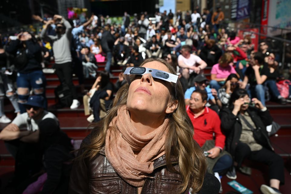 People gather in Times Square, New York to watch the solar eclipse