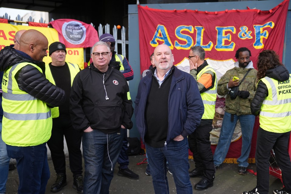 Aslef union members will be striking again next month led by Mick Whelan (centre)