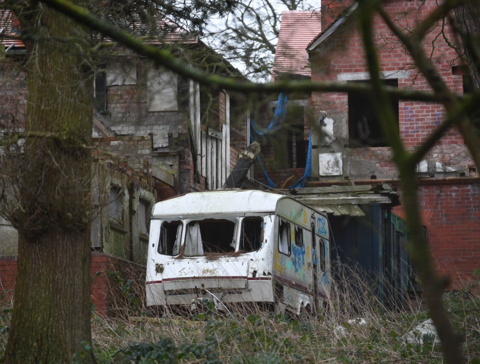 Now abandoned caravans sit outside the dilapidated mansion