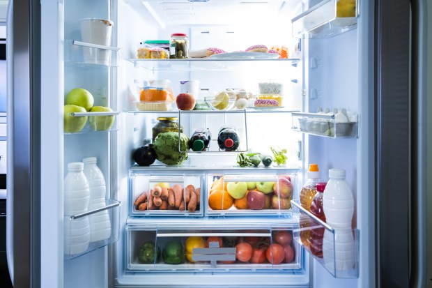 an open refrigerator filled with fruits and vegetables