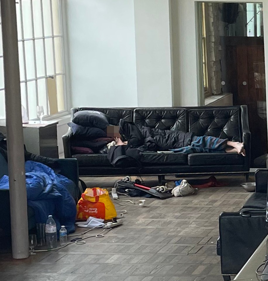 An occupier sleeps amid the trash at the Ramsay’s pub in London