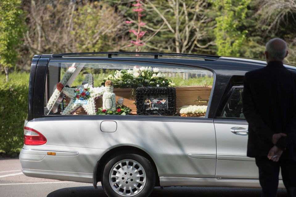 The hearse arrived donned with flower wreaths