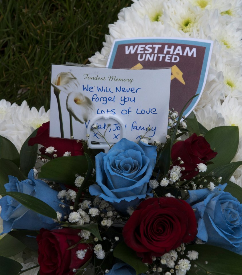 Claret and blue roses left with West Ham United badges in honour of the team George supported