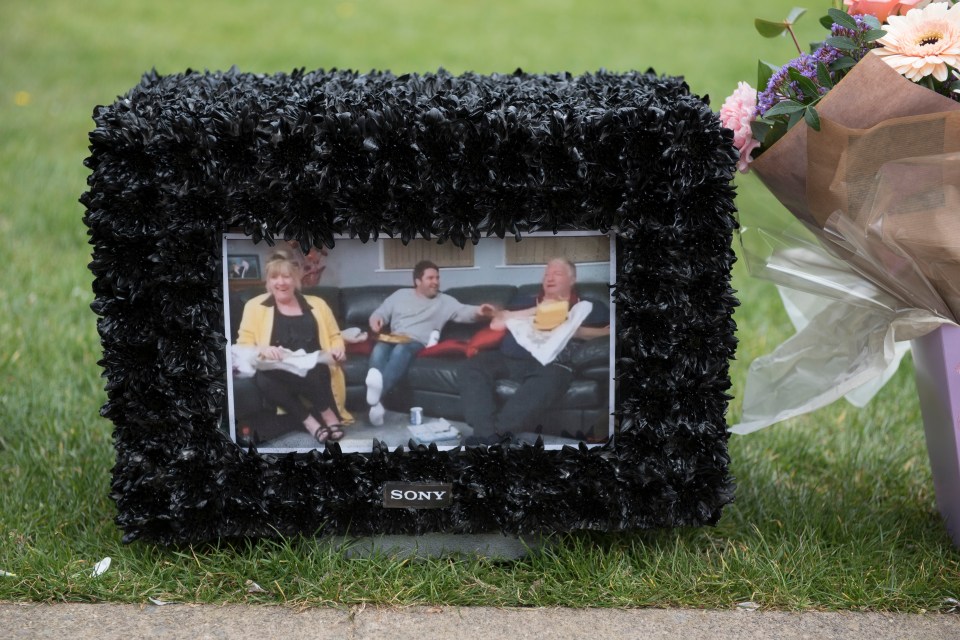 A touching picture of George while he appeared on Gogglebox was laid alongside flower bouquets